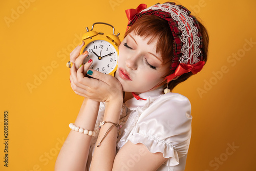 Картината върху платно A young girl in a studio on a yellow background
