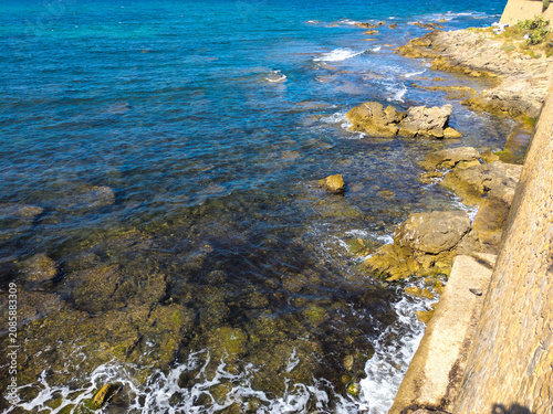 View of the clear sea from the bastions of the city walls of Alghero, Sassari, Sardinia, Italy