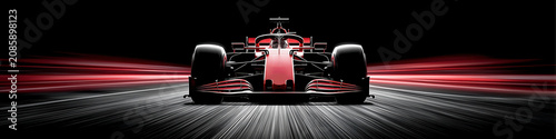Modern red Formula 1 racing car speeding on a track at night with motion blur light trails and high contrast lighting on a black background.