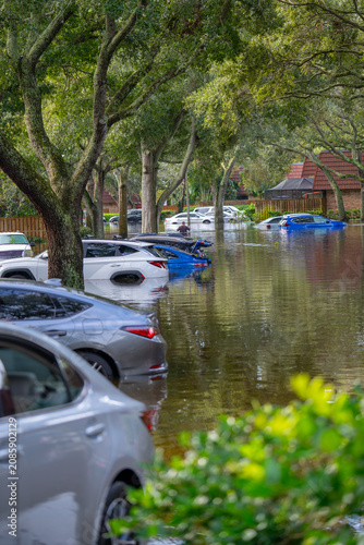 Florida after a hurricane. Flooded residential neighborhood with submerged cars flooded streets and homes. Weather natural disasters, climate change, flood damage, property insurance. Insurance claims