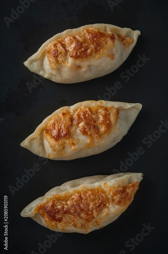 Delicious Dumplings Being Served Hot on a Dark Surface in a Kitchen