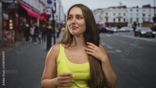 Fotografija Woman with hand covering mouth and visible tears on a crowded street; vulnerability distress solitude