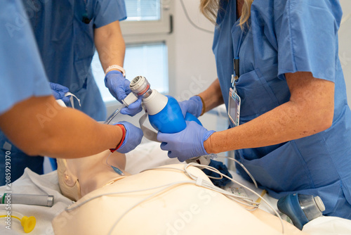 Healthcare professionals training resuscitation skills on mannequin