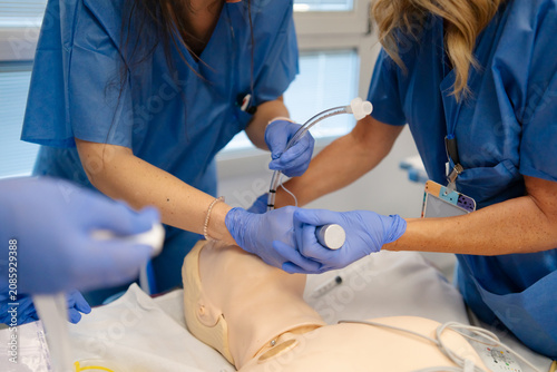 Medical students practicing intubation procedure on a mannequin