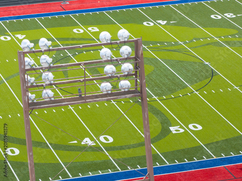 Drone shot captures wooden light tower over football field
