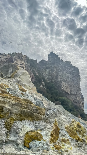 Konstfotografi Rock mountain landscape with clouds – Low-angle ground-level view of sulphur-encrusted volcanic formations near the geothermal area of Vulcano Island, Aeolian Archipelago, Sicily, Italy