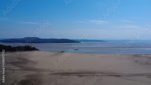 Aerial view of the Beach at Grange Over Sands showing the river Kent running past Arnside and into Morecambe Bay on a sunlit summers day