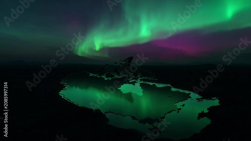 Vibrant aurora borealis shimmers above a dark, serene landscape reflecting the celestial display.