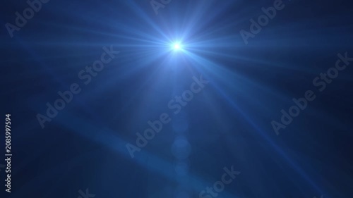 Bright blue light bursts into view with sharp rays. Deep blue background offers stark contrast