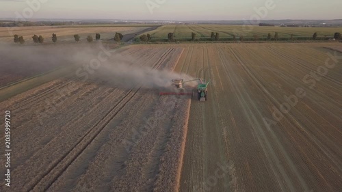 Aerial Reverse Drone Flight Following Combine Harvester in Harvested Field