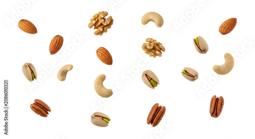 Assorted nuts floating in air almonds cashews pistachios pecans and walnuts arrangement