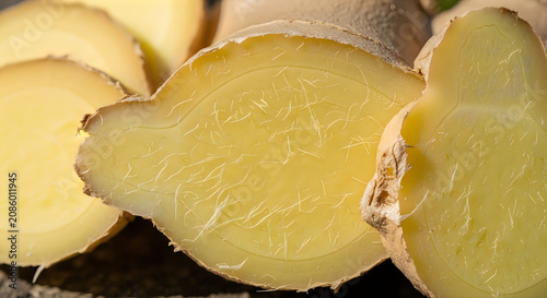 Fresh ginger root slices close up of cut ginger with fibrous texture and natural light