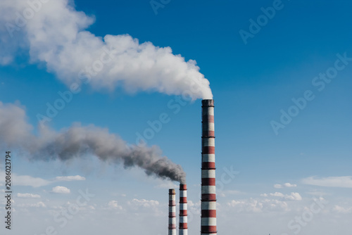 Fotografie Aerial close-up of an industrial smokestack at a power plant.
