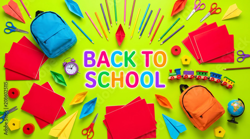 Back to school colorful text on electric lime green background with kids backpacks toy drones geometric circles
