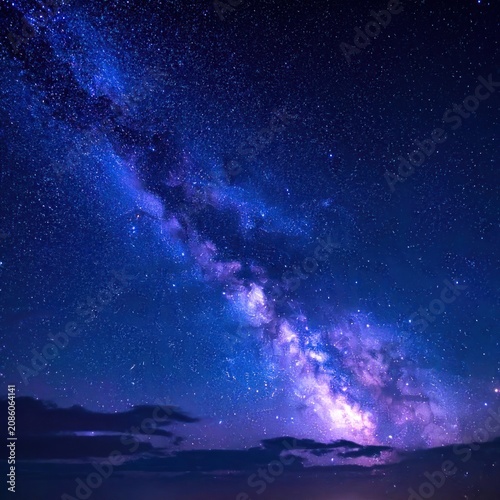 The vibrant Milky Way galaxy stretches across a starry night sky.