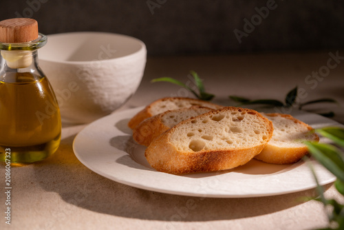 Rustic Sliced Artisan Bread with Olive Oil on White Plate, Cozy Food Photography