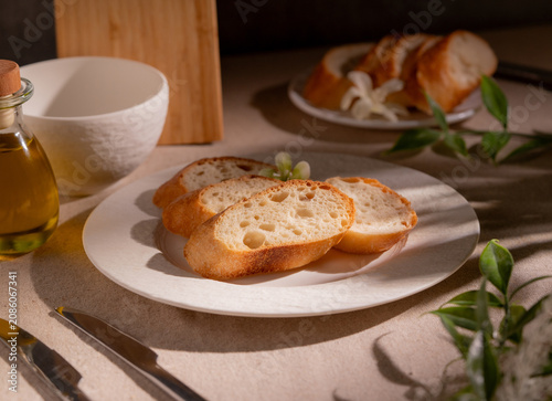 Rustic Sliced Artisan Bread with Olive Oil on White Plate, Cozy Food Photography