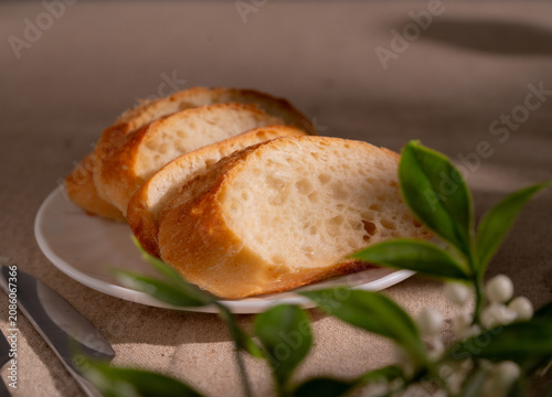 Rustic Sliced Artisan Bread with Olive Oil on White Plate, Cozy Food Photography