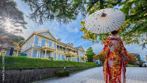 Young Japanese woman in a Traditional Kimono dress with Old public Hall of Hakodate in Hokkaido, Japan