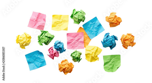 Colorful crumpled sticky notes scattered on a white background, conveying creativity and disorganization.