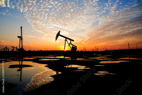The oil pump, industrial equipment. Oil field site, oil pumps are running.