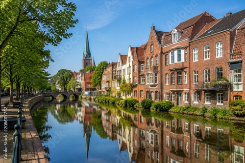 A tranquil canal with brick houses and reflections in Oldenburg.