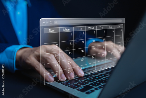 фотографія Business professional using a laptop with a virtual online calendar interface for appointment scheduling project planning task management, productivity digital workflow and time management technology