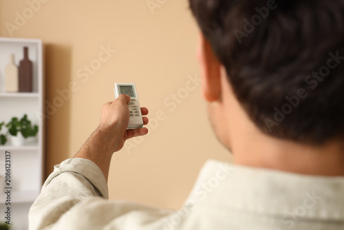 Man adjusting air condition...
