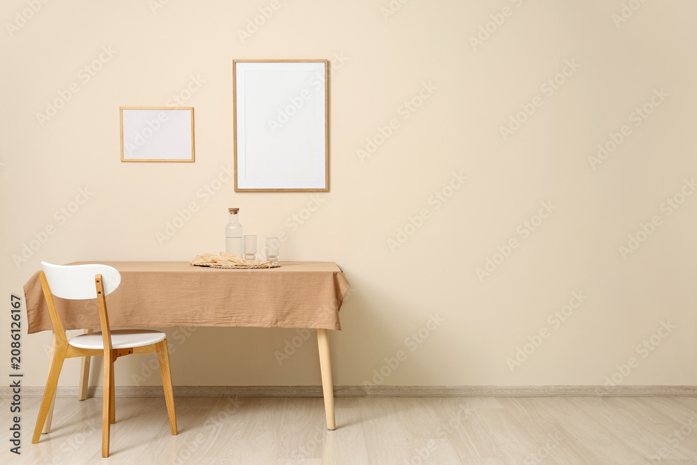 Fototapeta premium Minimalist dining table with chair and empty frames