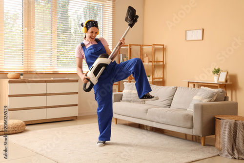 Woman dancing with vacuum c...