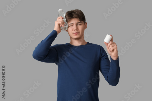 Young man with bottle of wa...