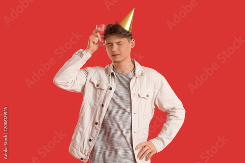 Young man with party hat an...