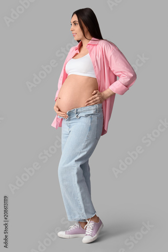 Young pregnant woman on lig...