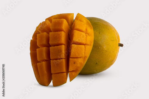 Fresh Ripe Yellow Mango Cut Hedgehog Style Attached to Half Isolated on White Background