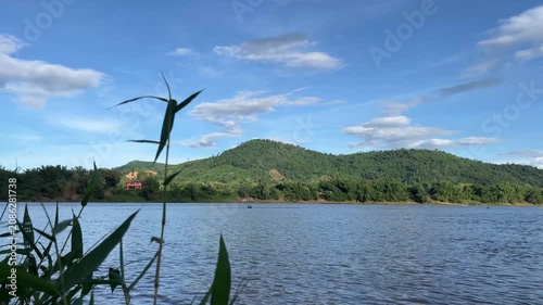 Peaceful Mekong River Landscape with Green Mountain and Blue Sky in Southeast Asia 4K