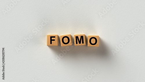 Photos FOMO Fear of Missing Out Acronym on Wooden Letter Blocks 3D render