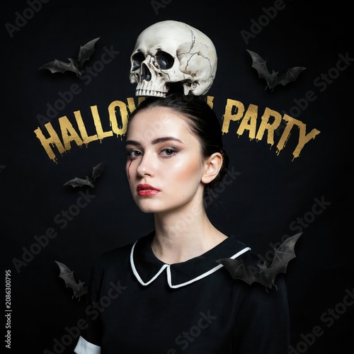 Woman in halloween costume with skull and bats