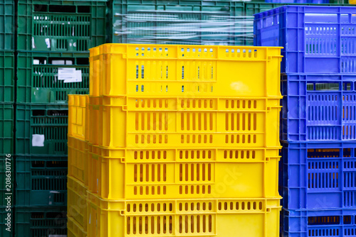 Colorful plastic crates arranged in industrial stacks