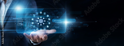 Fotografie Crypto trader operates a handheld console to open a virtual screen tracking modern DeFi (Finance) protocols