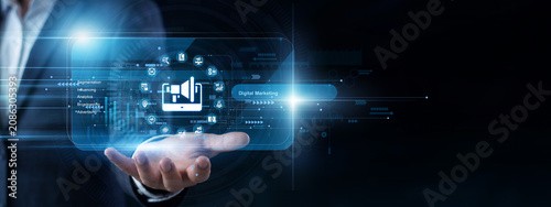 Foto Brand strategist uses a handheld device to view a virtual screen analyzing a fresh Digital Marketing campaign