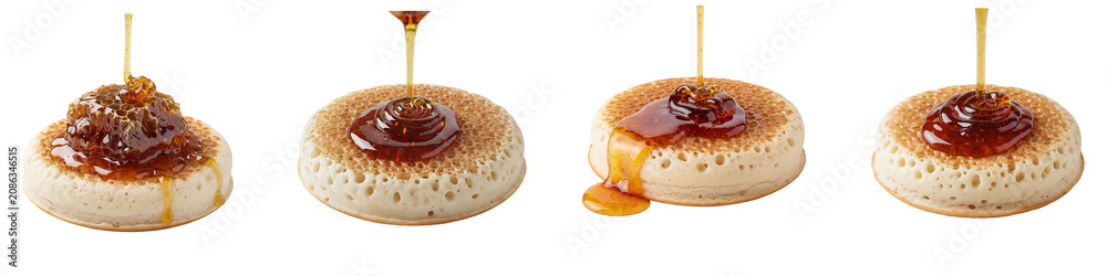Fototapeta premium Honey pouring over fresh crumpets and honeycomb on black background