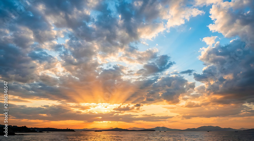 Radiant sunset sky with golden glow illuminating dramatic clouds in a peaceful atmosphere