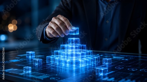 Digital business architecture and tech foundation concept with a hand building a glowing blue holographic cube pyramid