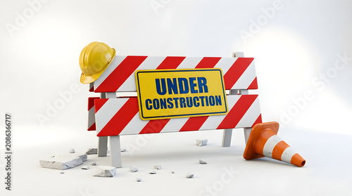Under construction sign with barrier and safety gear on white