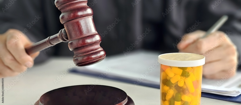 Obraz premium Court proceeding involving prescription medications and a judge gavel during a legal