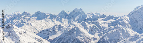 White snowy winter Caucasus mountains at sunny day. Panorama view from ski slope Elbrus, Russia