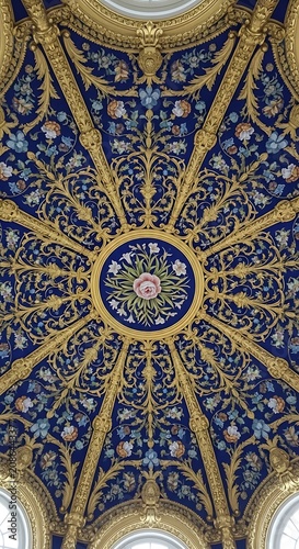 Intricate golden mosaic ceiling with ornate patterns and symbols.
