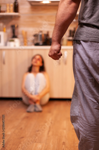 фотографія Defenseless young woman faces an aggressive husband, showing fear, bruises and physical abuse linked to domestic violence and alcohol problems