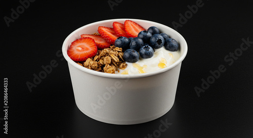 Yogurt bowl with fresh strawberries, blueberries and granola