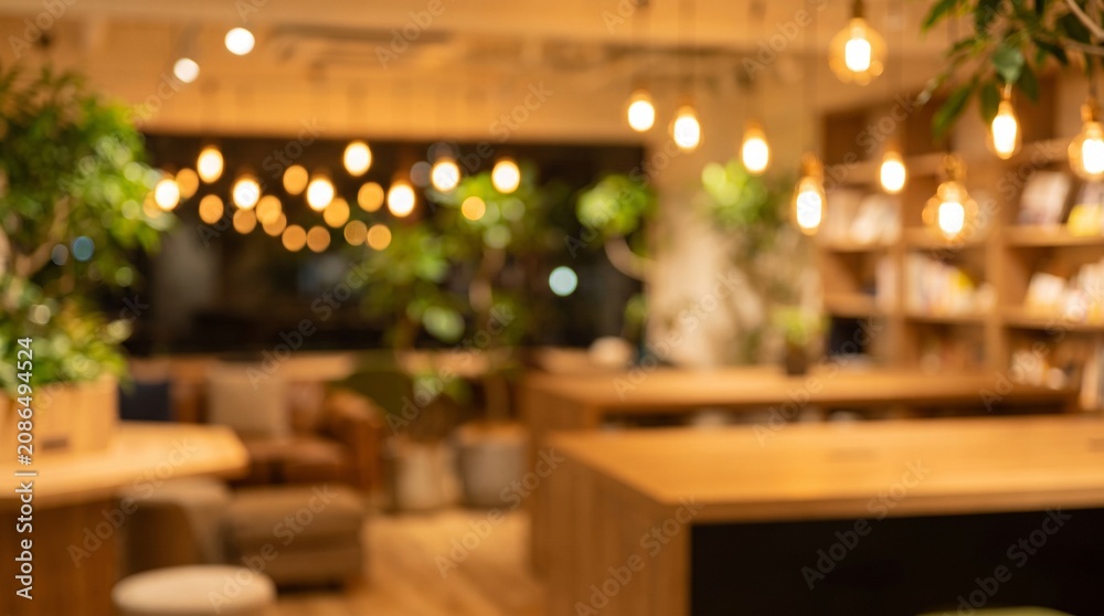 Obraz premium Blurred Modern Office Interior with Warm Lighting and Indoor Plants